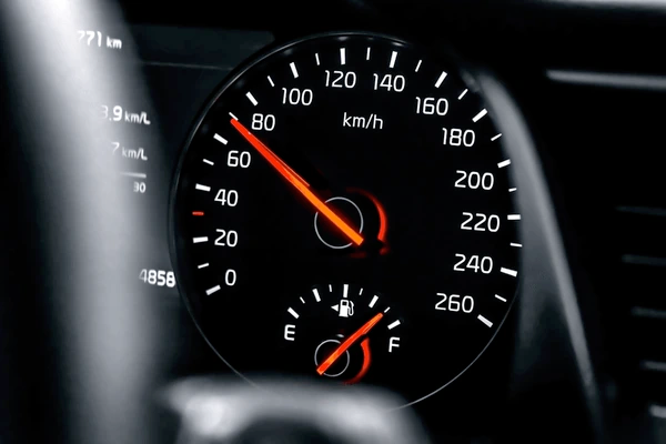 A glowing digital speedometer interface representing fast insurance quote generation and speed of service